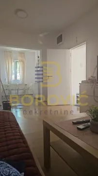View from the living room towards the dining area and doors. - image 3