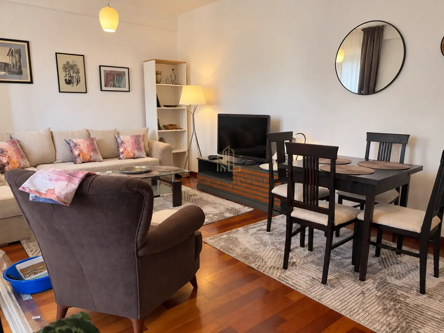 Living room with a sofa set, television, and dining table.