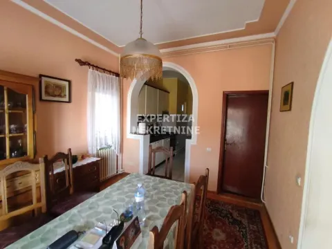 Dining room with a table and chairs and a view towards the kitchen. - image 13