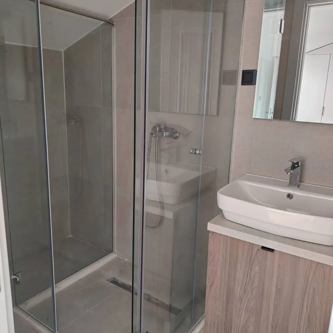 Modern bathroom with a walk-in shower and a vanity unit.