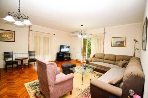 Spacious living room with a sofa set, armchair, and dining table. - image 7
