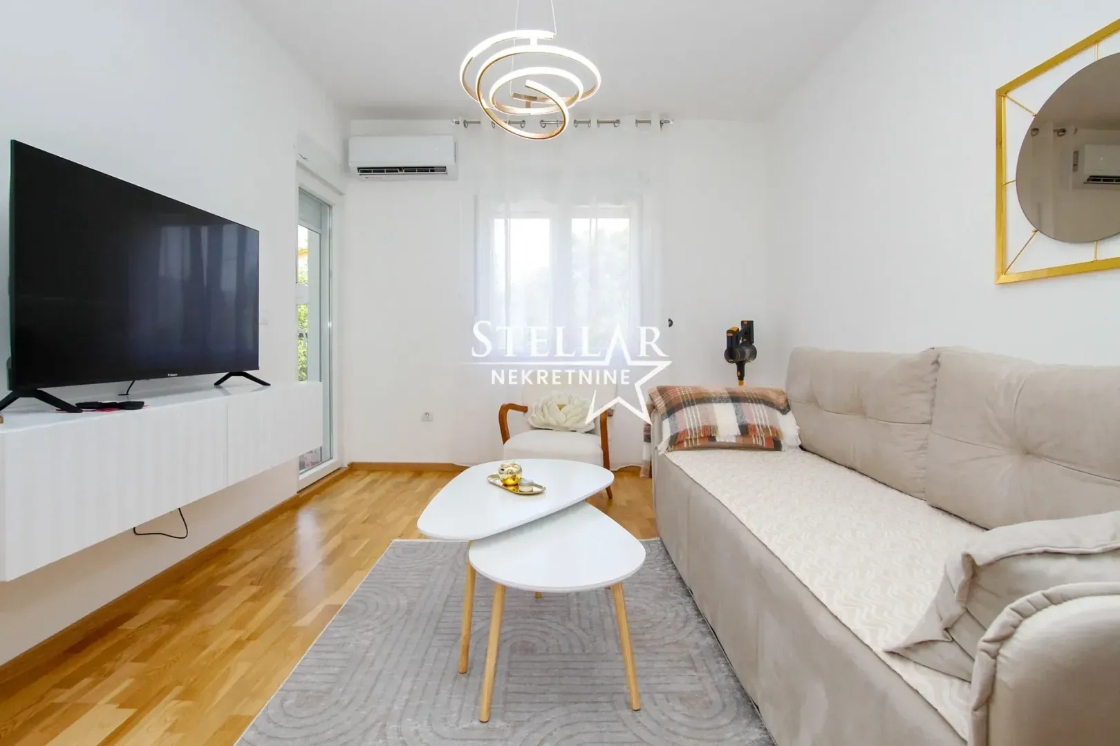 Living room with sofa, TV and coffee table.