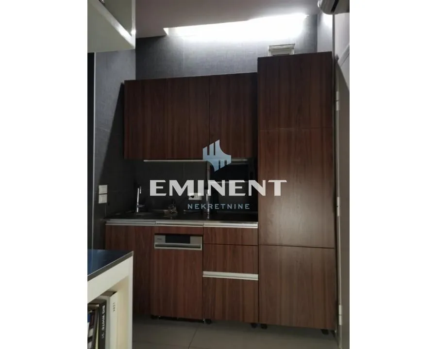 Small kitchen with dark wood cabinets.