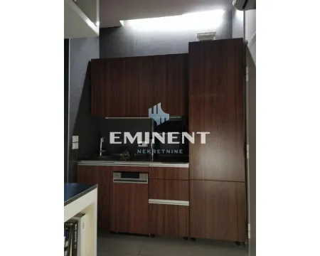 Small kitchen with dark wood cabinets. - image 3