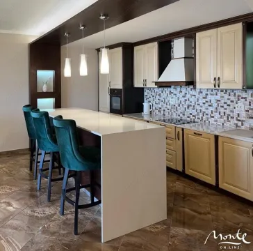 Modern kitchen with a breakfast bar and blue bar stools. - image 3