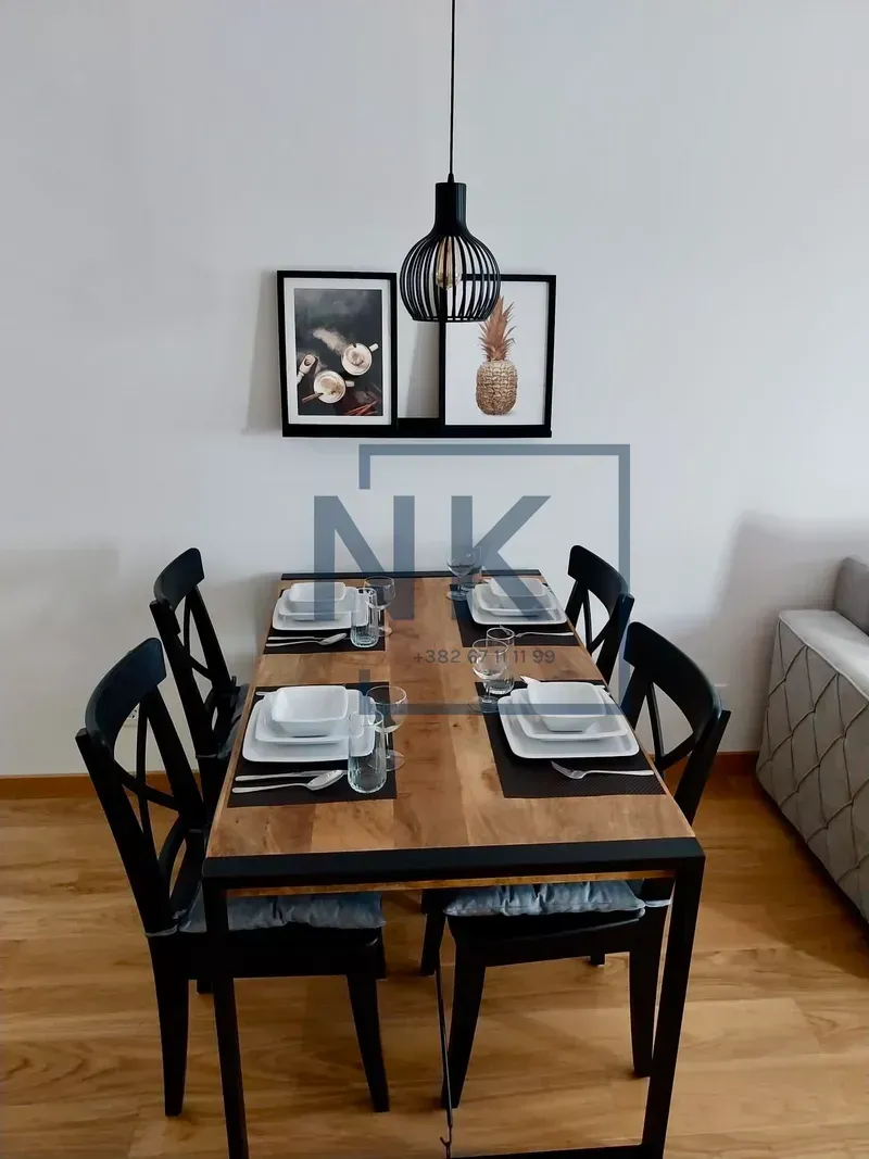 Dining area with a wooden table and black chairs.