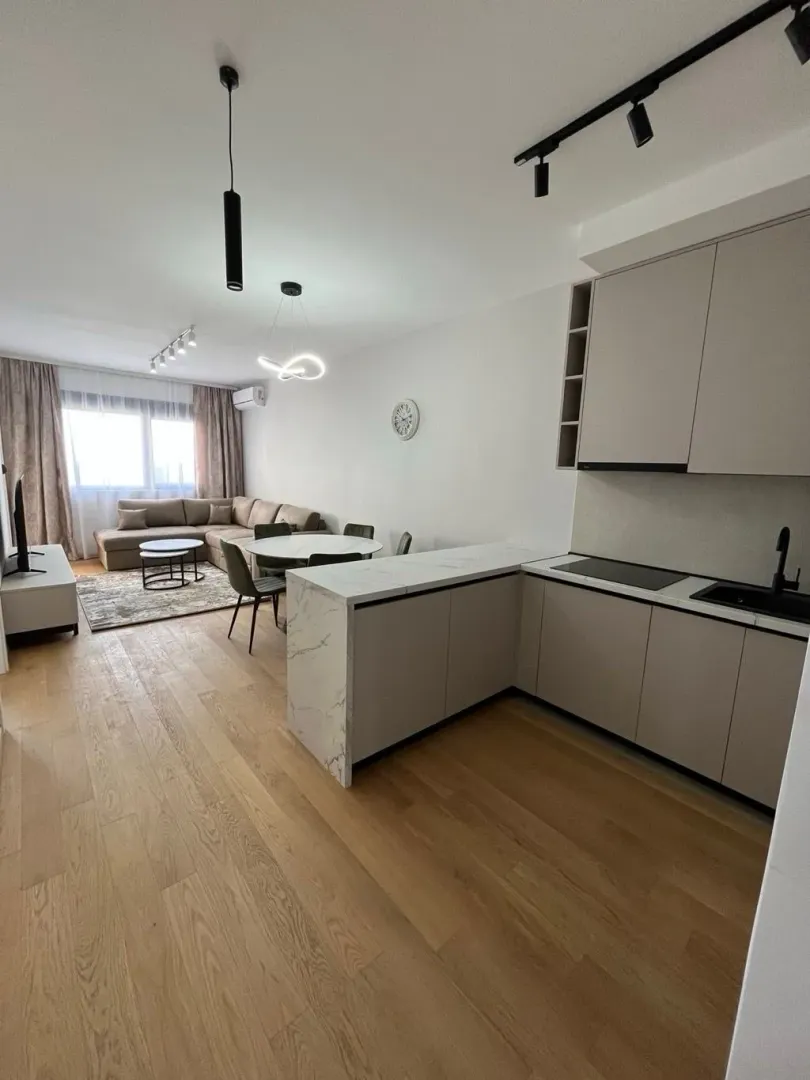 Modern open-plan space combining the kitchen, dining area, and living room.