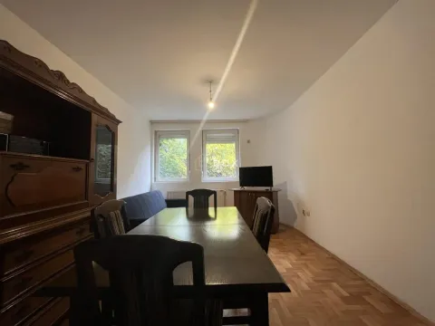 Living room with a dining table, sofa set and parquet flooring. - image 2