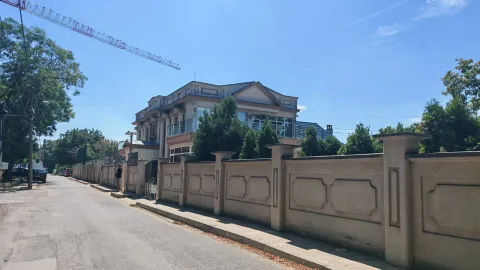 Exterior view of the house with a courtyard and fence. - image 8