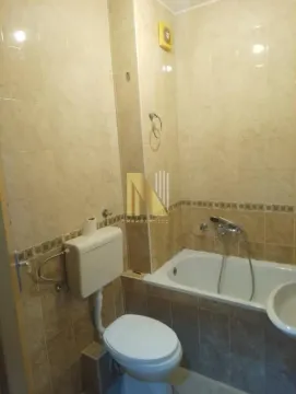 Manje kupatilo obloženo keramičkim pločicama sa kadom i toaletom. - image 10
