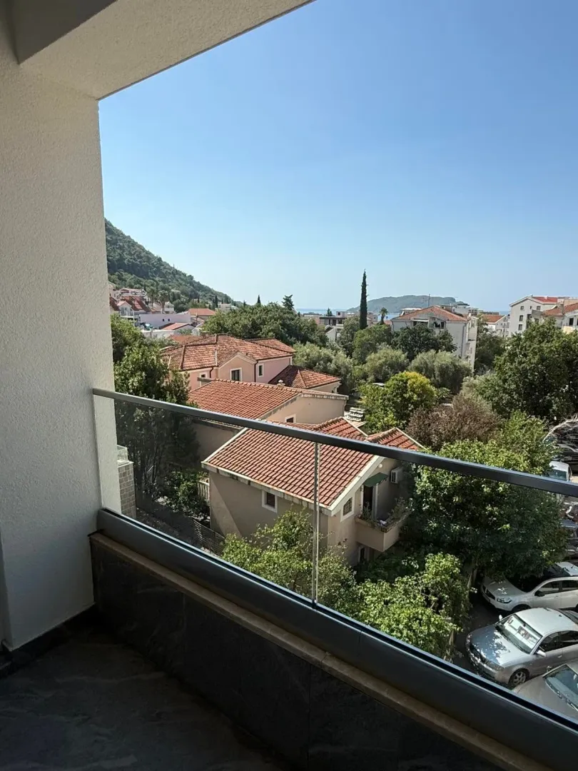 Pogled sa balkona na okolne kuće i zelenilo.