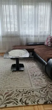 Living room with a corner sofa and a coffee table by the window. - image 7