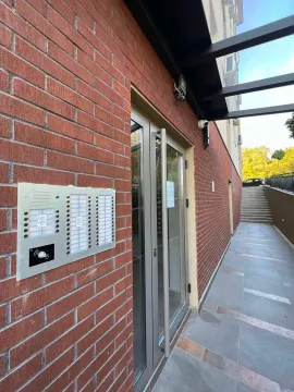 Building entrance with an intercom and stairs. - image 18