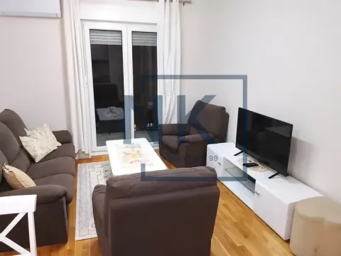Living room with a sofa set, TV stand and access to the terrace. - image 2