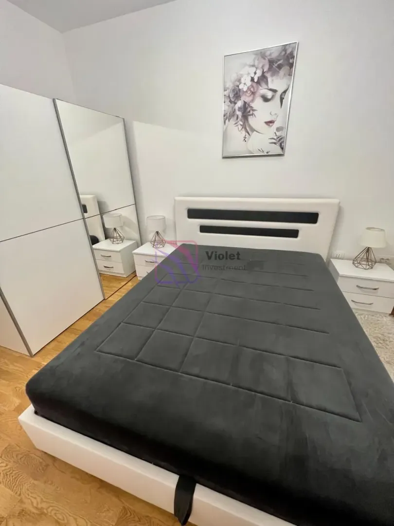 Furnished bedroom with a double bed, wardrobe, and nightstands.