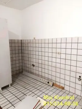 Empty kitchen with ceramic tiles on the walls and floor. - image 8