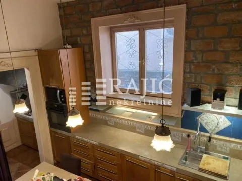 Wooden kitchen with a stone wall and brick details. - image 14