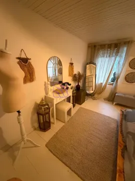 Bedroom with a bed, white furniture piece, and decorative elements. - image 13