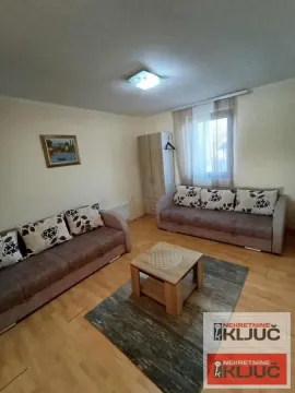 Living room with two sofas, a coffee table, and a window. - image 8