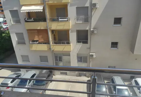View from the balcony overlooking the building facade and parking lot. - image 11