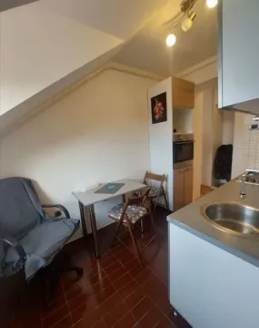 Small kitchen with a dining table and chairs in the attic. - image 7