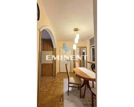 Living room with a dining table and parquet flooring. - image 4