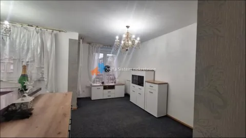 Living room with white furniture and a chandelier. - image 2
