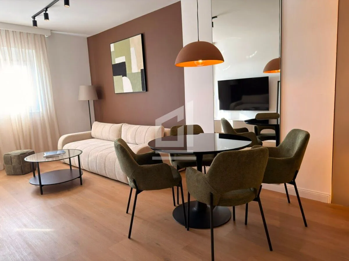 Living room with a dining area and modern furniture.