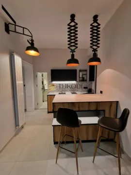 Modern kitchen with a kitchen island and black bar stools. - image 5