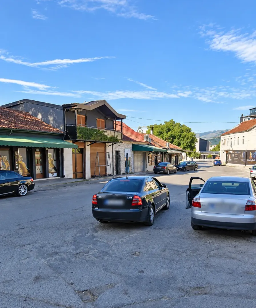 View of the street and building exteriors with ground-floor commercial spaces.