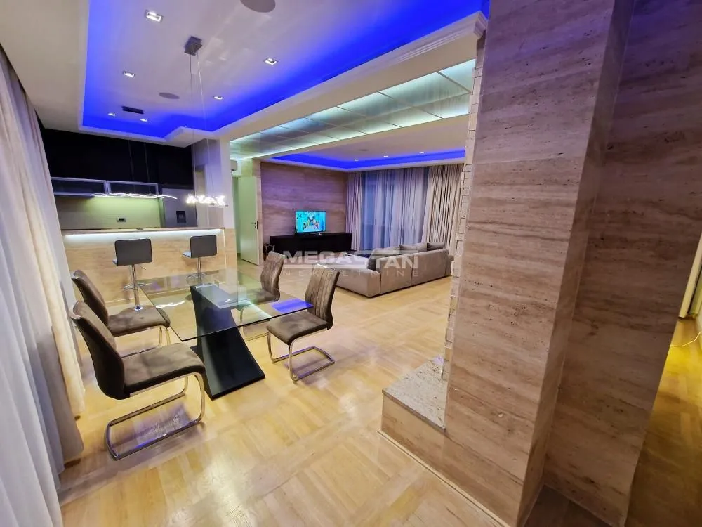Spacious living room with dining area and modern ceiling lighting.