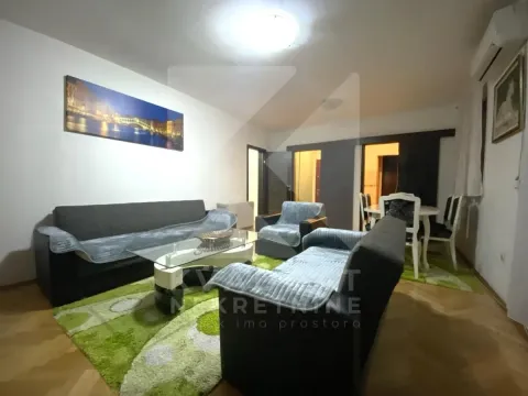 Living room with a sofa set, coffee table, and a dining area in the background. - image 4