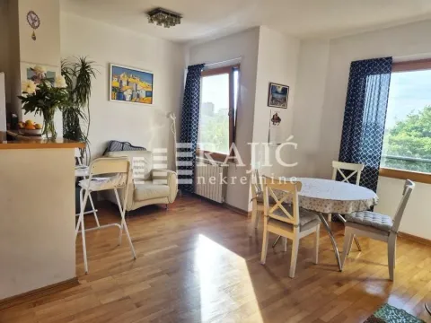 Living room with dining area and wooden flooring. - image 5