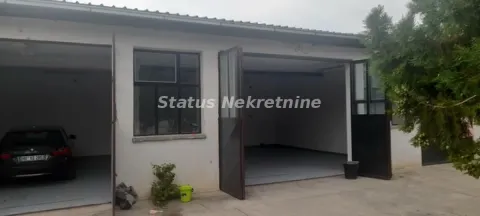 View of the garage with open doors and a parked car. - image 3