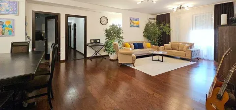 Spacious living room with seating furniture, dining table and wooden flooring. - image 10