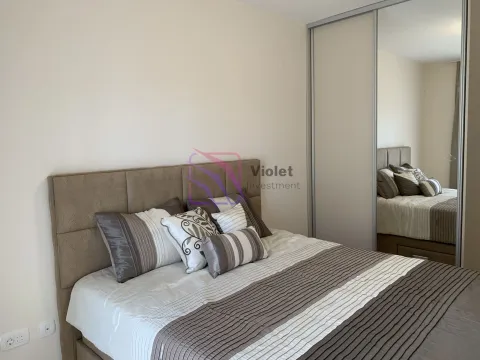 Bedroom with a double bed and a fitted wardrobe with a mirror. - image 4