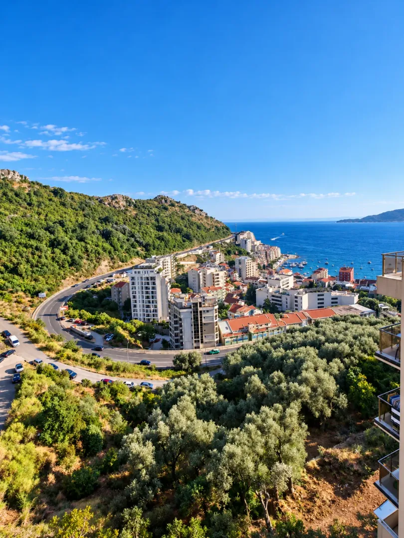 View from the terrace overlooking the settlement, greenery, and the sea coast.