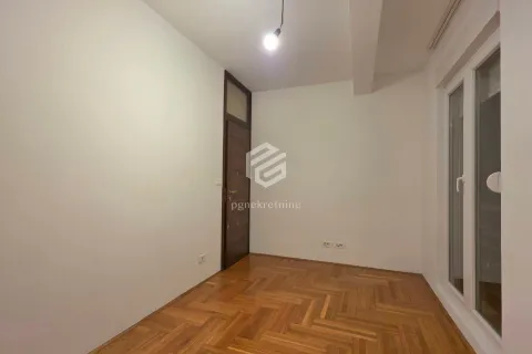 Empty room with parquet flooring and a door. - image 8
