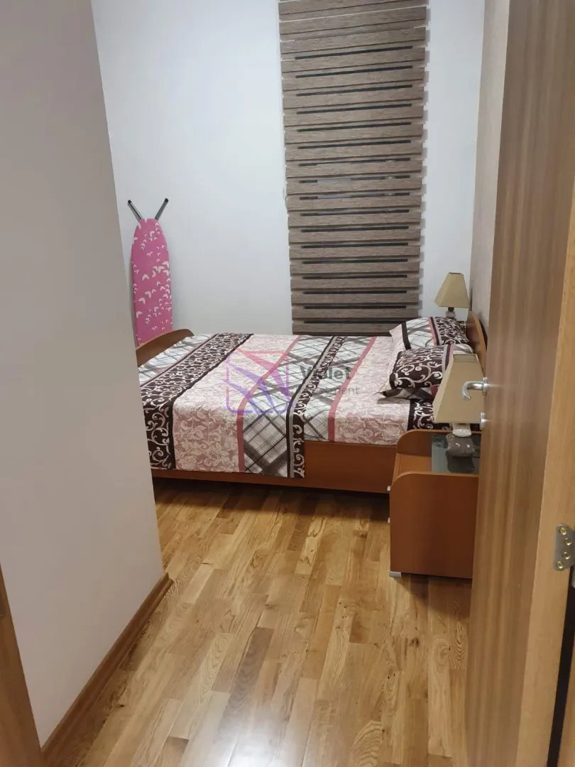View of the bedroom with a double bed through an open door.