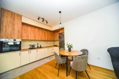 Kitchen with a dining area equipped with wooden cabinets and built-in appliances. - image 4