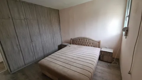 Bedroom with a double bed, wardrobe, and nightstands. - image 8