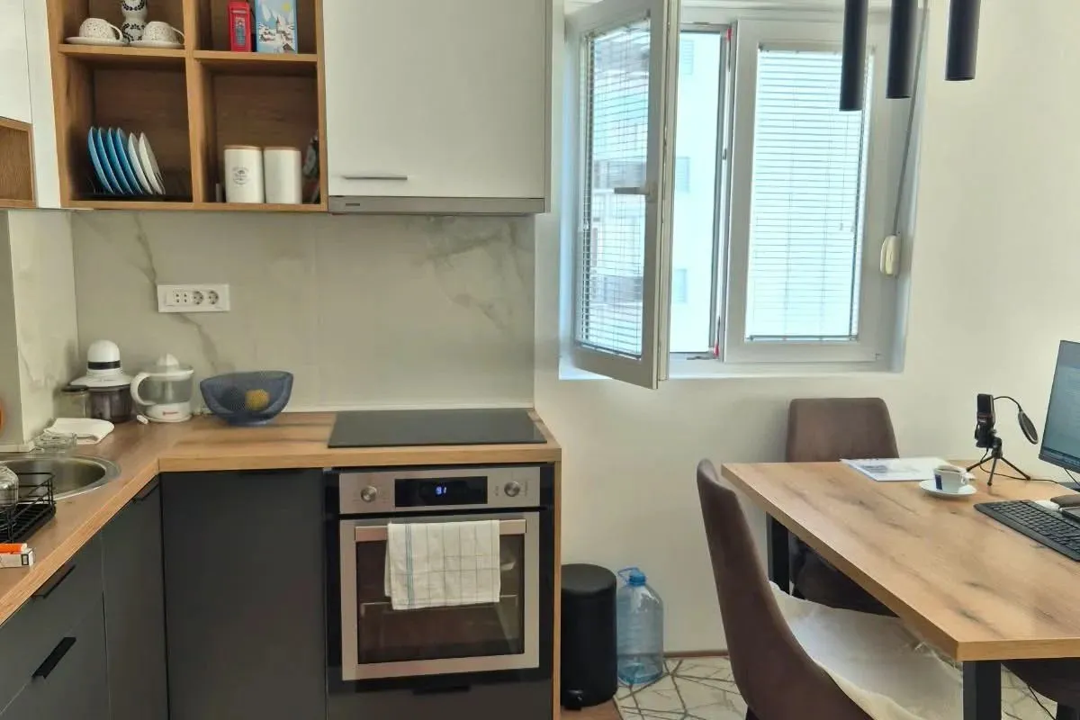Modern kitchen with a dining table and window.