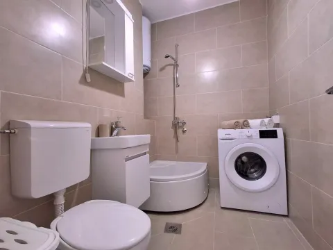 Moderno opremljeno kupatilo sa tuš kabinom i veš mašinom. - image 8