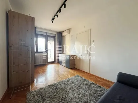 Living room with parquet flooring, a rug, and a wardrobe. - image 6