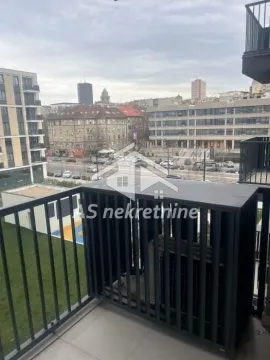 View from the balcony overlooking city streets and surrounding buildings. - image 10