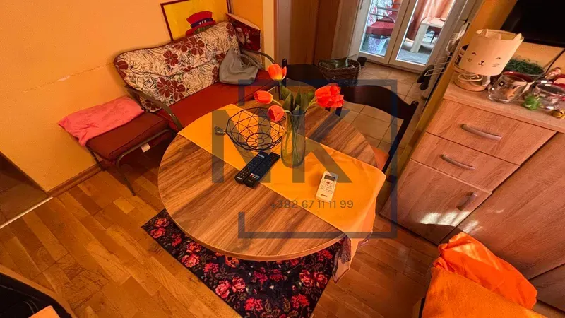 Smaller living room with a dining table and a sofa.