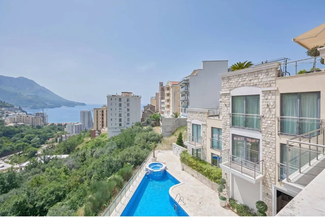 Exterior view of the residential building with a swimming pool and sea view.