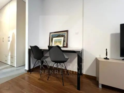 A desk with chairs against the wall in the living room. - image 5