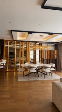 Spacious living room with a dining area and modern ceiling lighting. - image 2