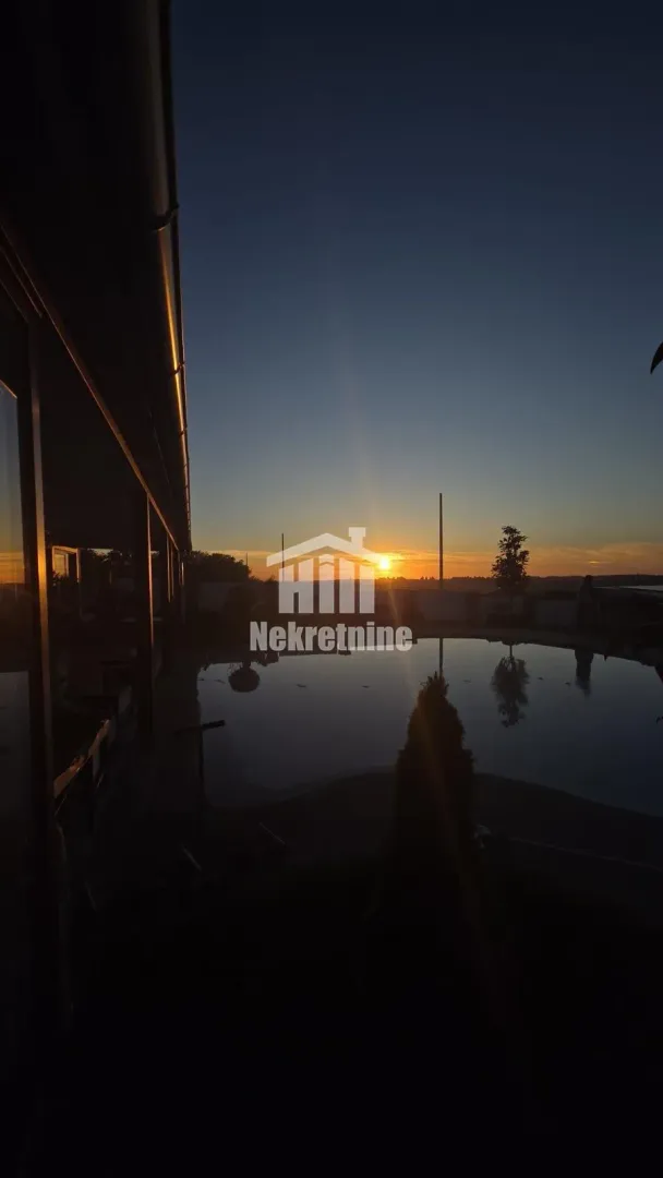 View of the yard and swimming pool at dusk.